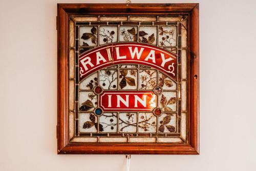 a sign in a wooden frame on a wall at The Railway in Skipton