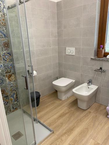 a bathroom with a toilet and a sink at CASCINA LAI - Oasi Naturalistica - Camere private in Santena