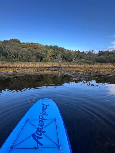 a view of the back of a kayak in the water at Dunmore Cottage in Tarbert