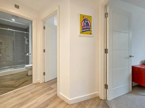 a room with a bathroom with a toilet and a door at The Post House One by Fortuna Property in Gloucester