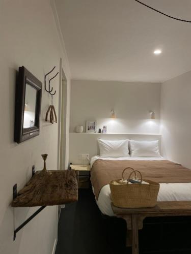 a bedroom with a bed with a table and a mirror at stay early mansion 가산, 홍대, 고척돔 in Seoul