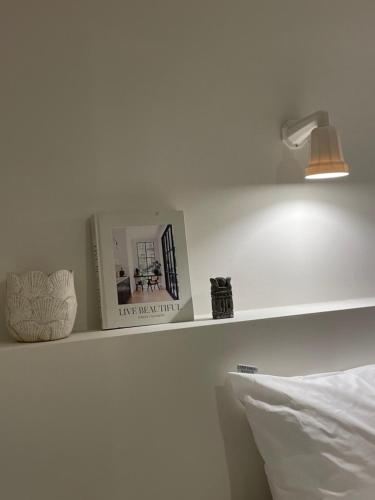 a shelf with a light and a book and a lamp at stay early mansion 가산, 홍대, 고척돔 in Seoul