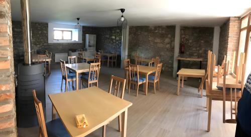 a restaurant with tables and chairs in a room at El Rincón De Cabello in Sierra