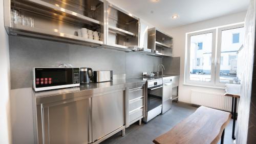 a kitchen with stainless steel appliances and a window at Gemütliches Zimmer im Herzen der Stadt in Neuwied