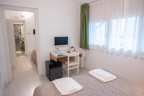 Un pat sau paturi într-o cameră la Hotel Giardino