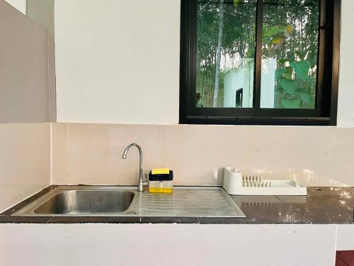 a kitchen with a sink and a window at Cozy Hideaway 2 BR Private Room Shared House in Ban Tha Khun