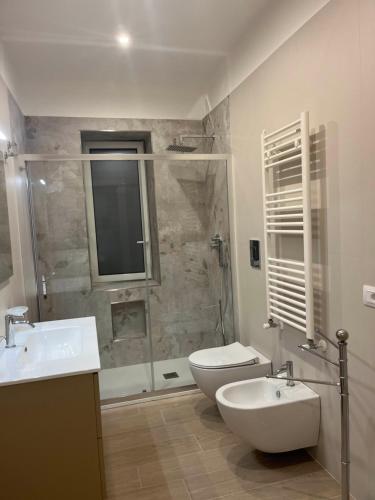 a bathroom with a shower and a toilet and a sink at Nancy's Home in Naples