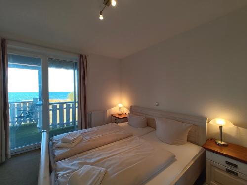 ein Schlafzimmer mit einem Bett und einem großen Fenster in der Unterkunft Mitteldeck 503 in Rechlin