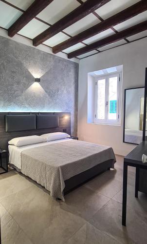 a bedroom with a large bed and a window at Borgo Marchetti in Camerano