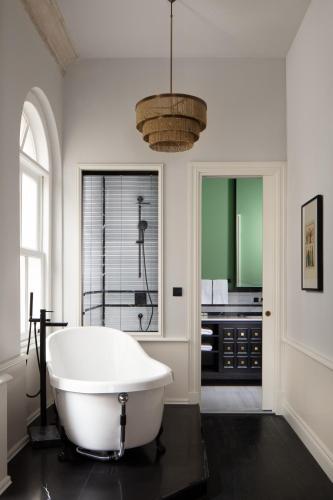 a bathroom with a white tub and a sink at Adahan DeCamondo Pera, Autograph Collection in Istanbul