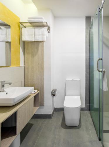 a bathroom with a toilet and a sink at DOMO By Design Union in Lagos