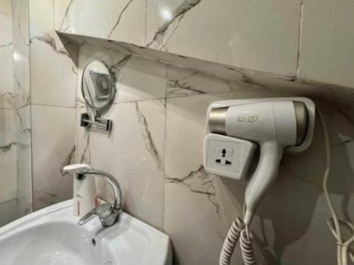 y baño con secador de pelo junto a un lavabo. en Gannet Alyousef City Center, en Naj‘ al Maḩaţţah