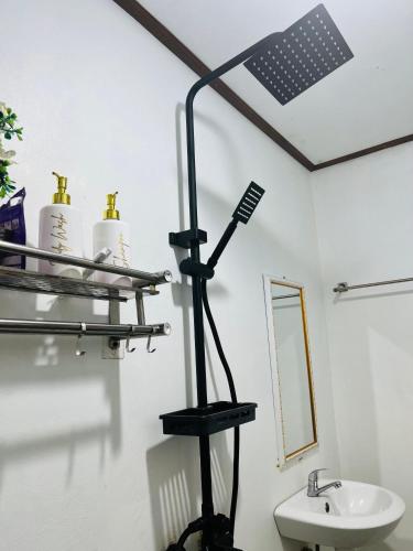 a black light in a bathroom with a sink at pinggan box glamping in Bangli