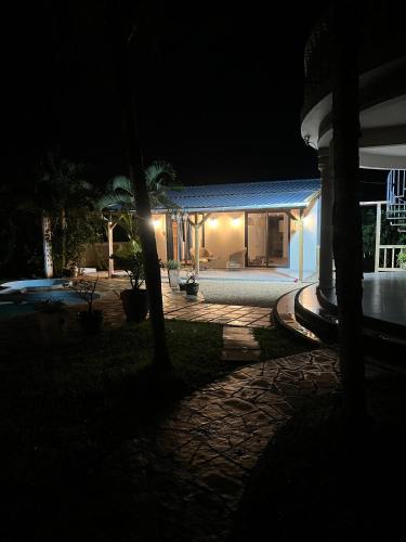 una casa con techo azul por la noche en Palmiste Villa, en Mare dʼAlbert