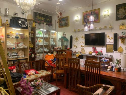 a dining room with a table and chairs and a tv at Rest Point 7 in Veyangoda
