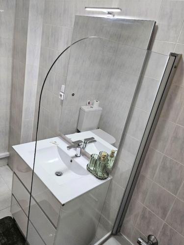 a bathroom with a sink and a mirror at LUCINDA`S HOUSE in Braga