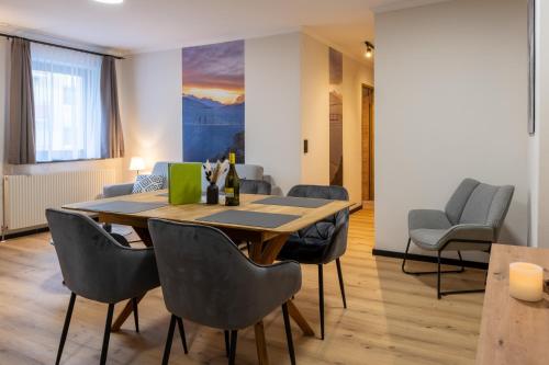 a dining room with a table and chairs at Bergblick Appartements in Bad Gastein