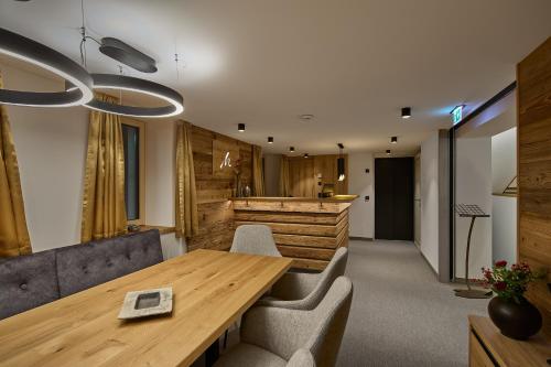 a conference room with a wooden table and chairs at Die Monika Aparthotel in Gaschurn