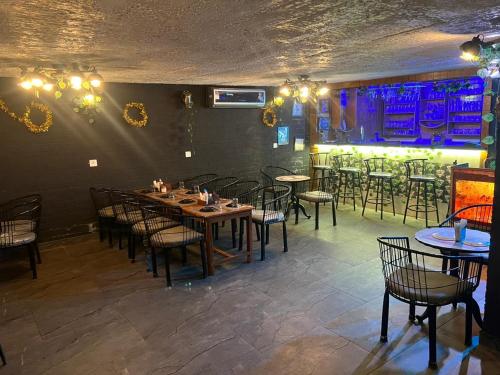 a room with tables and chairs in a restaurant at Khalsa Lake View Resort in Jāmb