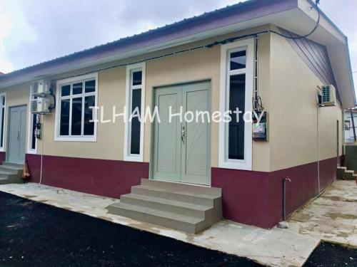 a small house with stairs in front of it at ILHAM homestay in Kota Bharu