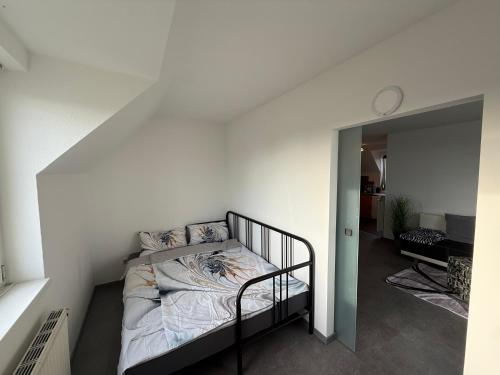 a bedroom with a bed in a white wall at City Dachterassen Traum in Vienna