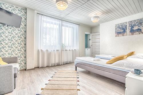 a bedroom with a bed and a large window at Pod Wodospadem in Szczyrk
