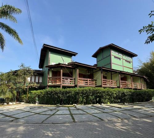 a green building with aventh floor at Recanto Verde Praia Hotel Juquehy in Juquei