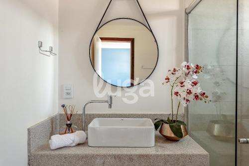 ein Badezimmer mit Waschbecken und Spiegel in der Unterkunft Vieira Eco Pousada #4 in Orleans