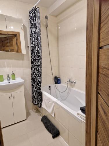 a bathroom with a bath tub and a sink at VIN service Dzelzcelnieku street 19 in Rēzekne