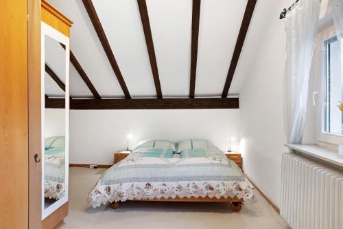 a bedroom with a bed with a wooden ceiling at Haus Palais in Münstertal