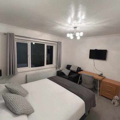 a bedroom with a bed and a desk and a chair at Glebeside House in Satley