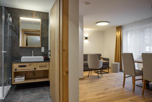 a bathroom with a sink and a mirror at Die Monika Aparthotel in Gaschurn