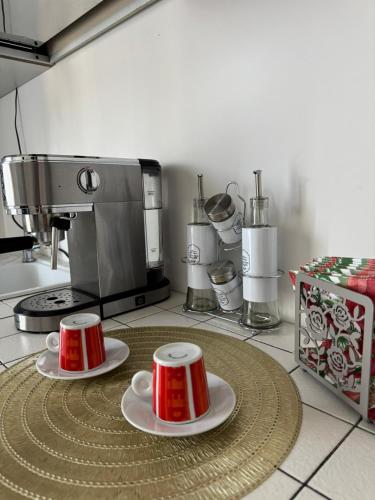 a kitchen with two cups and a coffee maker at IELLE Suite Brutia in Cosenza