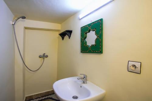 a bathroom with a sink and a shower at Riad BAB JDID in Fès