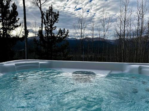 a hot tub with a view of the mountains at Secluded Custom 5 BR with Panoramic Mountain Views in Alma