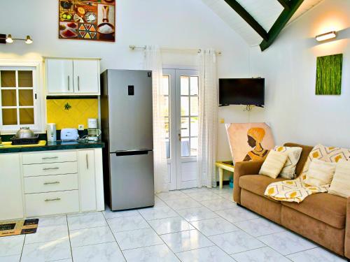 Η κουζίνα ή μικρή κουζίνα στο Le Sable Bleu - Évasion tropicale - Idéal Couples & Familles - PLAGE 5min - Piscine - Parking privé - Logement climatisé - Vue sur les palmiers - Restau snack familial sur place