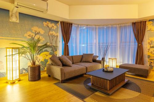 a living room with a couch and a table at Cozy Stay Sapporo Central in Sapporo