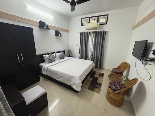 a bedroom with a bed and a tv in it at Lokosha Resort - The Green Destination in Hatikhuli