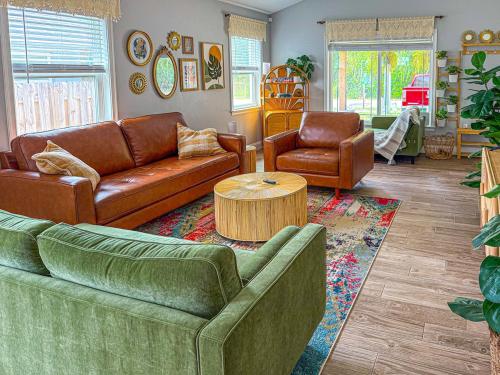 a living room with two couches and a coffee table at Rainbow River Bungalow with Early Checkin! in Dunnellon