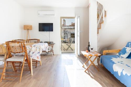 a living room with a bed and a table at River & Beach Apartment near Lisbon in Trafaria