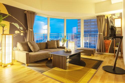 a living room with a couch and a table at Cozy Stay Sapporo Central in Sapporo