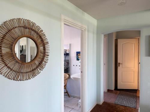 a mirror hanging on a wall in a bathroom at Appartementen met uniek zeezicht in Egmond aan Zee