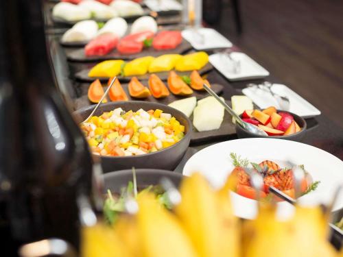 サンパウロにあるプルマン サンパウロ ヴィラ オリンピアの果物や野菜のボウルが並んだビュッフェ