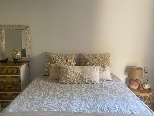 a bed with a blue comforter and pillows in a bedroom at Rony by Best Holidays Fuerteventura in Corralejo