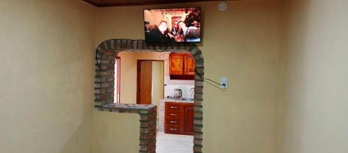 a living room with a tv on top of a brick wall at Luz de la puna in La Quiaca