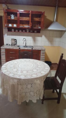a kitchen with a table and a chair and a sink at Luz de la puna in La Quiaca