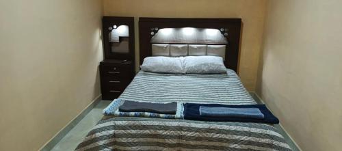 a bedroom with a large bed with a wooden headboard at Luz de la puna in La Quiaca