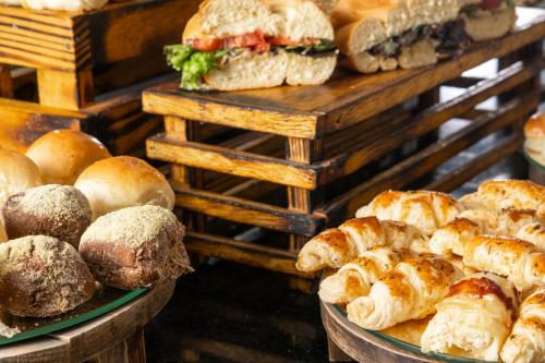 a bunch of different types of bread and pastries at Américas Copacabana Hotel in Rio de Janeiro