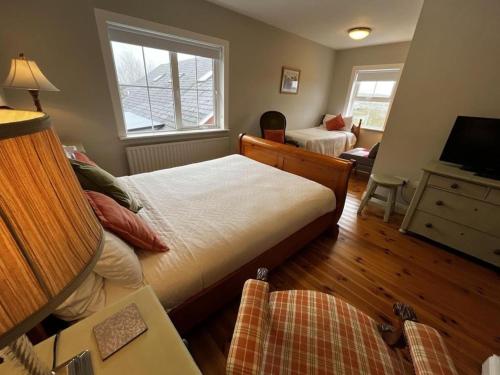 a bedroom with a bed and a desk and a television at Hillview House, Donegal Town in Donegal