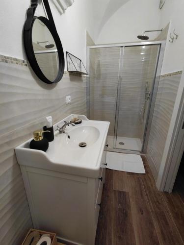 a white bathroom with a sink and a shower at La Ginestra in Bastia
